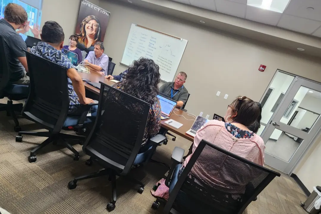 Staff members at OPTIONS Transitions to Independence in a planning meeting discussing student support strategies