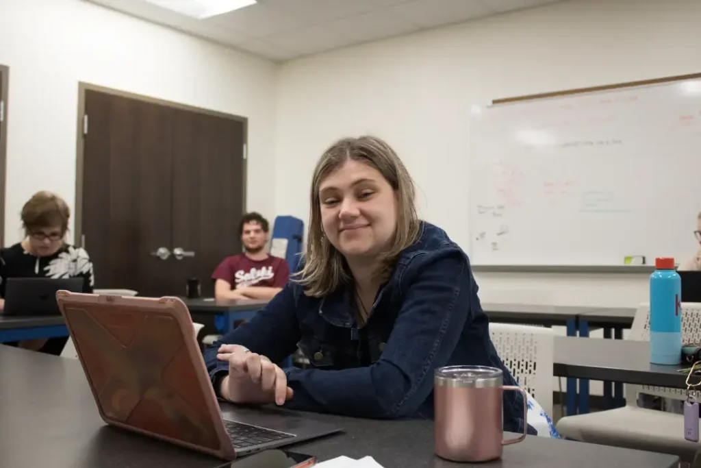 OPTIONS student using a laptop during an academic learning session