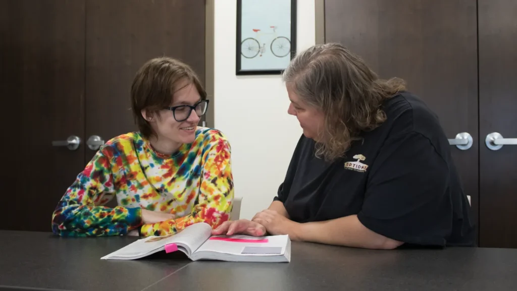 OPTIONS staff member working with a student during an advising and support conversation