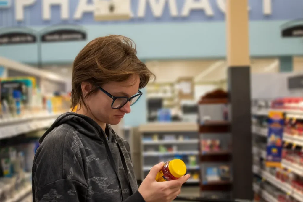 OPTIONS student comparing products while practicing grocery shopping and budgeting skills