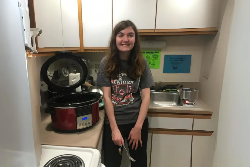 OPTIONS student practicing laundry and household management skills